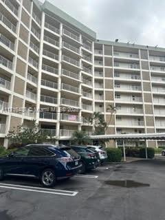 a front view of a building with parking space and parking space