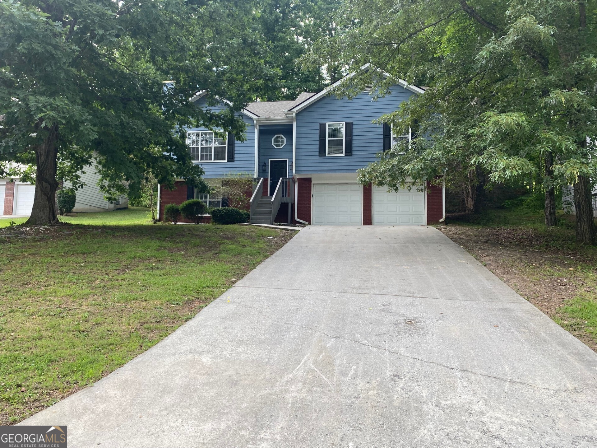 a front view of house with yard and trees