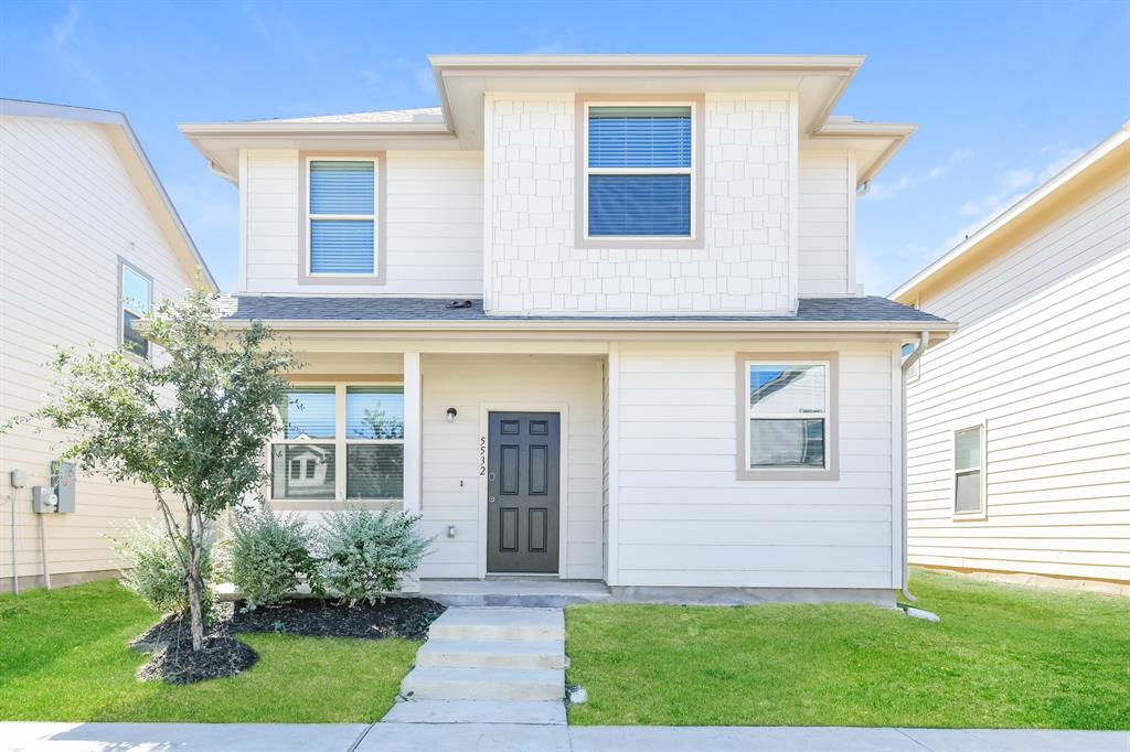 a front view of a house with a yard