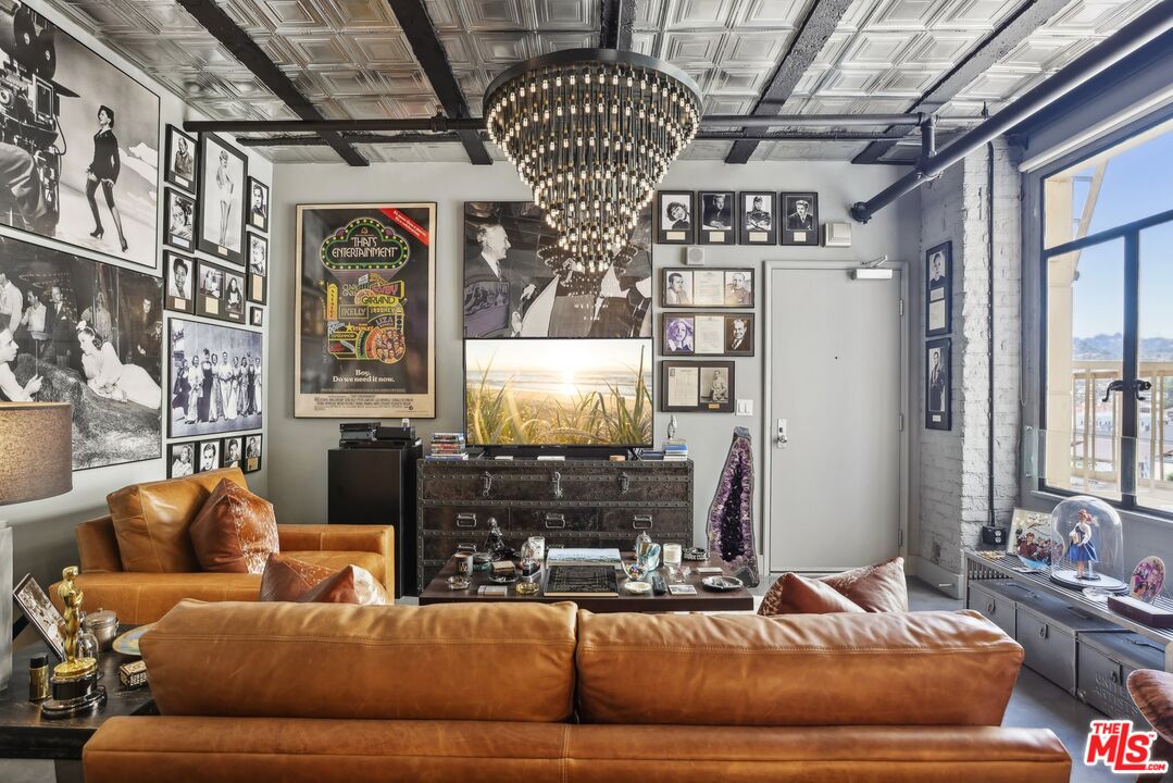 a living room with furniture a chandelier and a fireplace