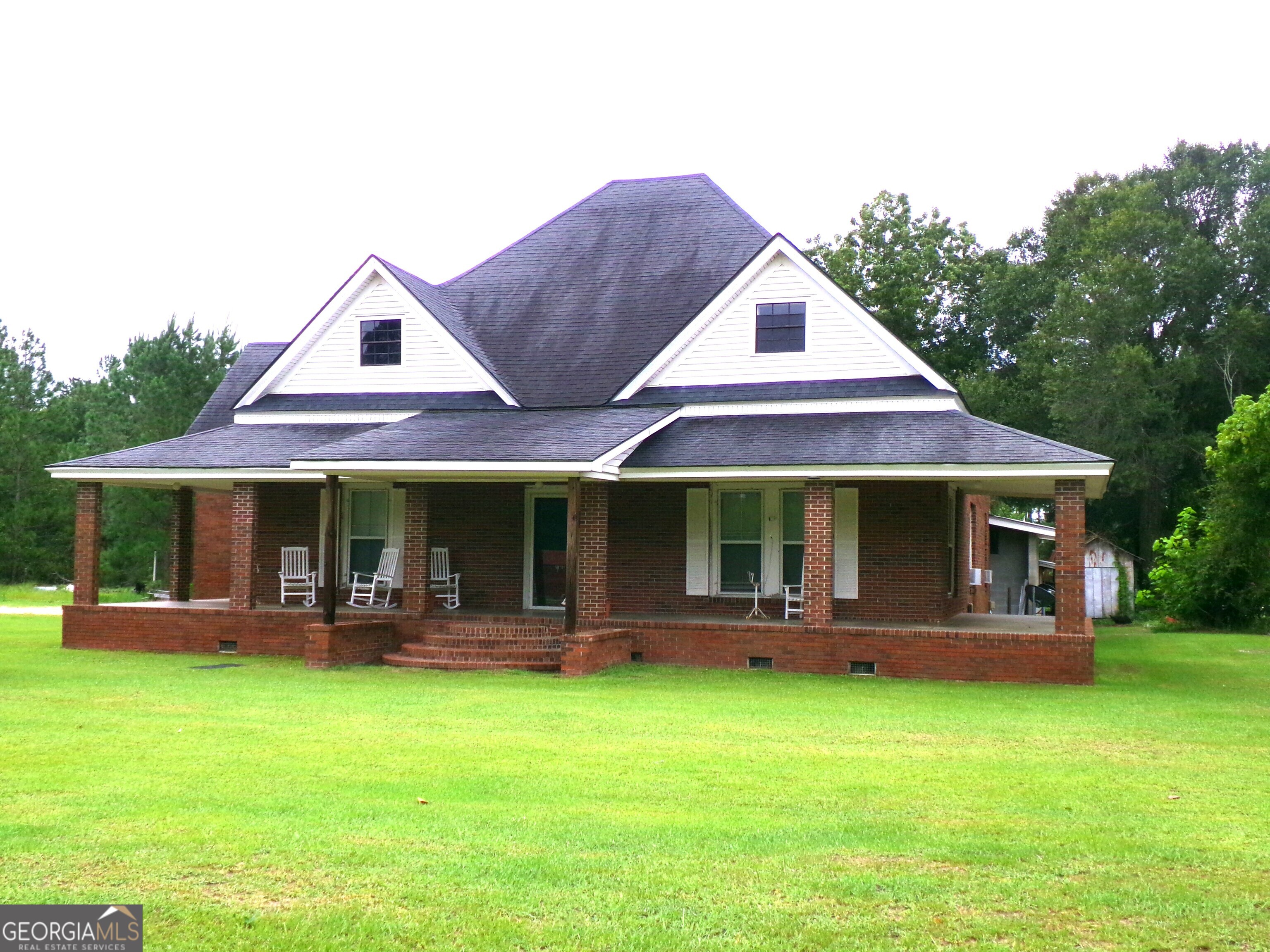 a front view of a house with a garden and porch