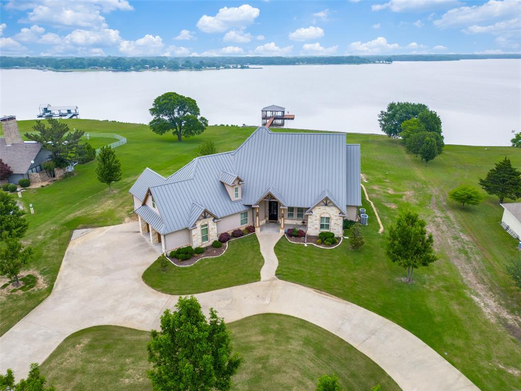 an aerial view of a house with garden space and street view