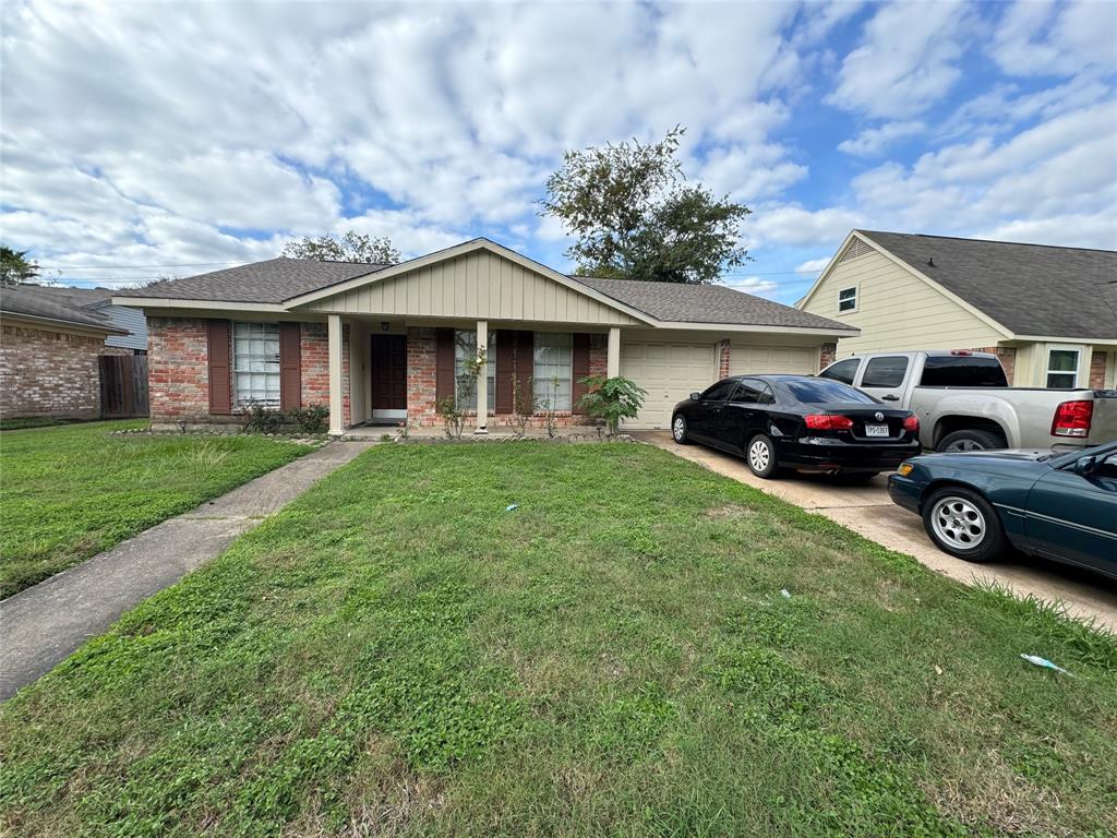 a view of a house with a cars park side of a road