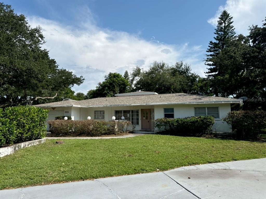 a front view of house with yard and green space