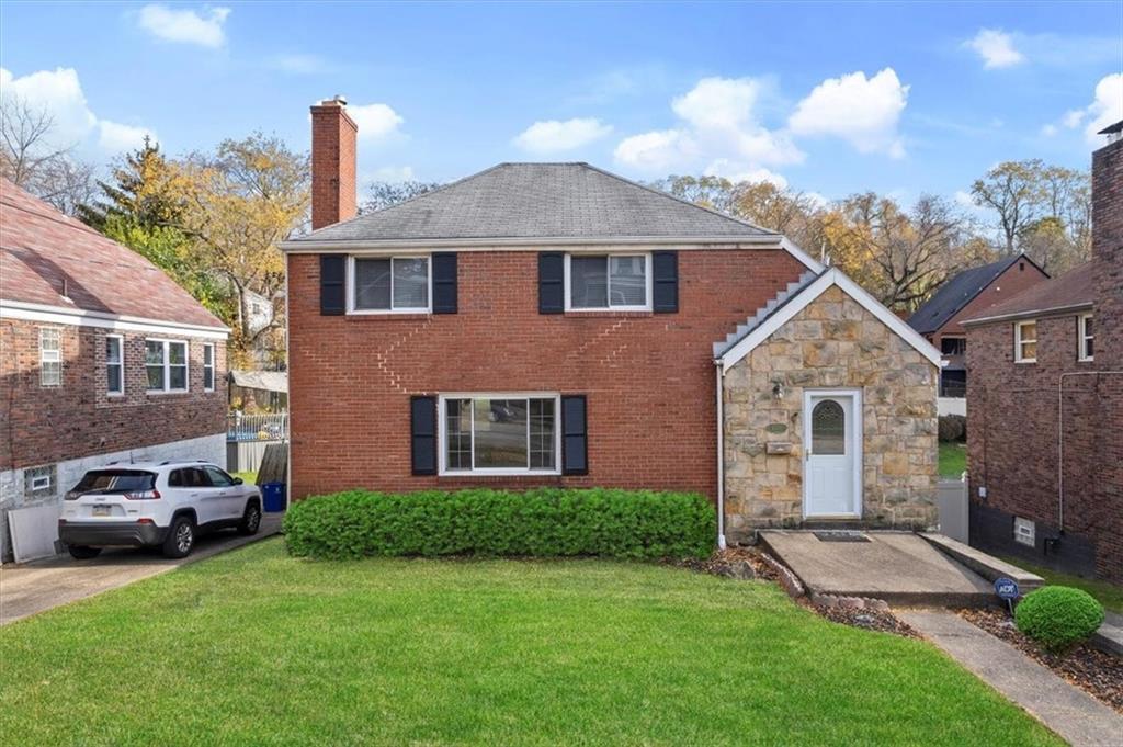 a front view of a house with a garden