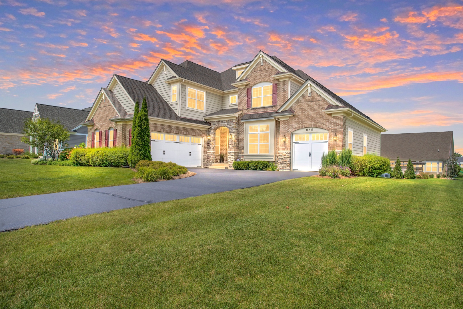 a front view of house with yard and green space