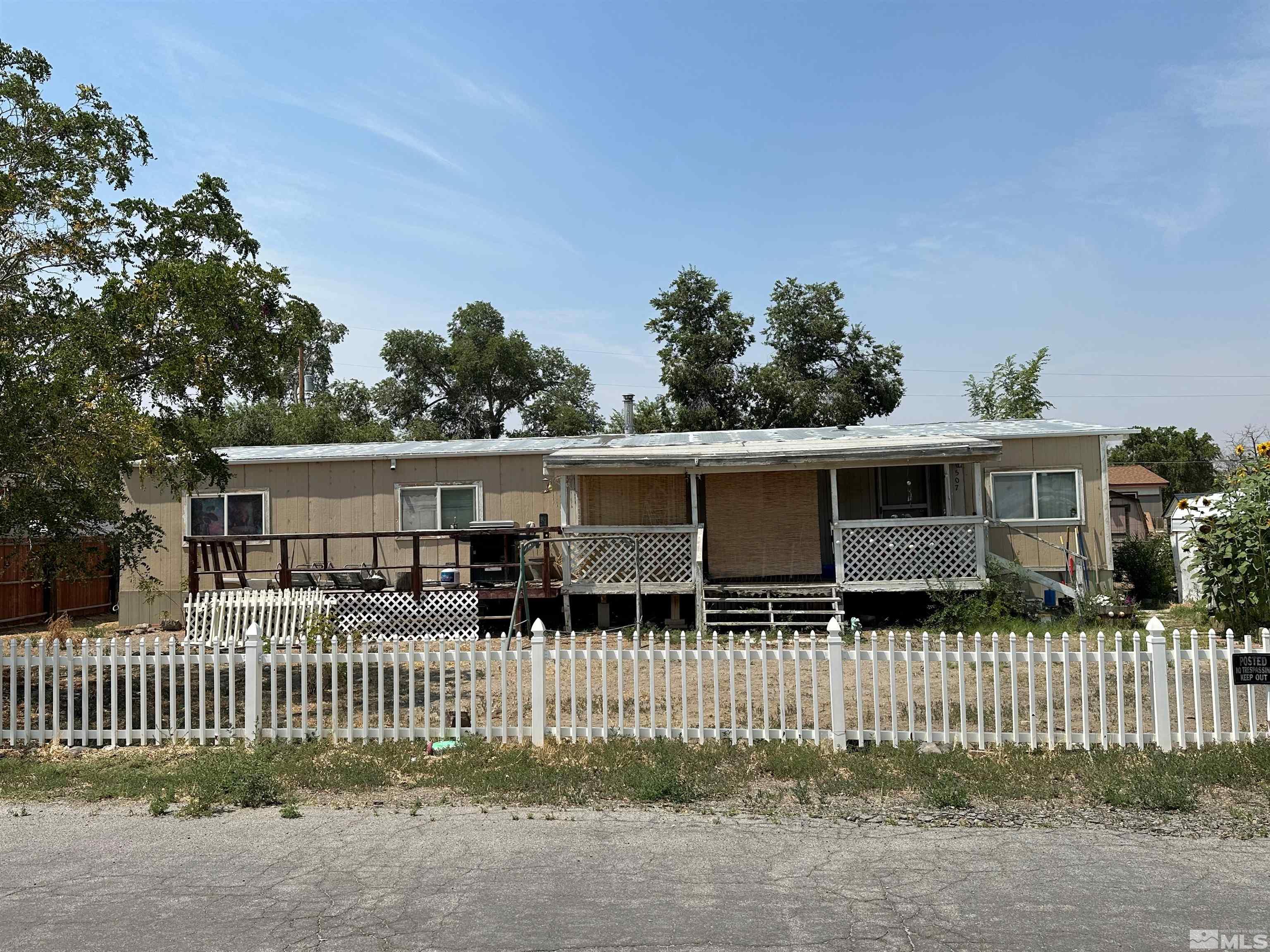 a front view of a house with a fence