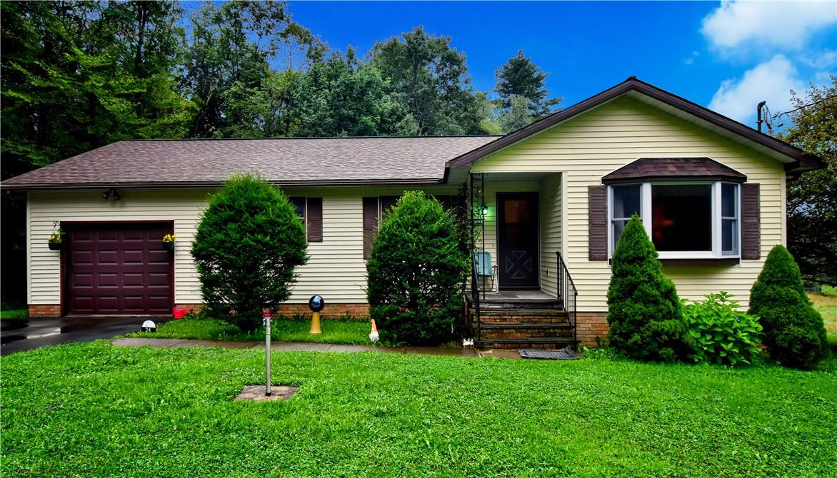 Single story home with a front yard and a garage