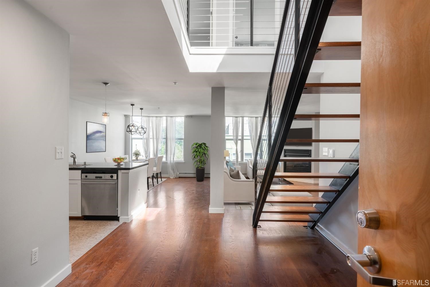 a view of entryway and hall with wooden floor