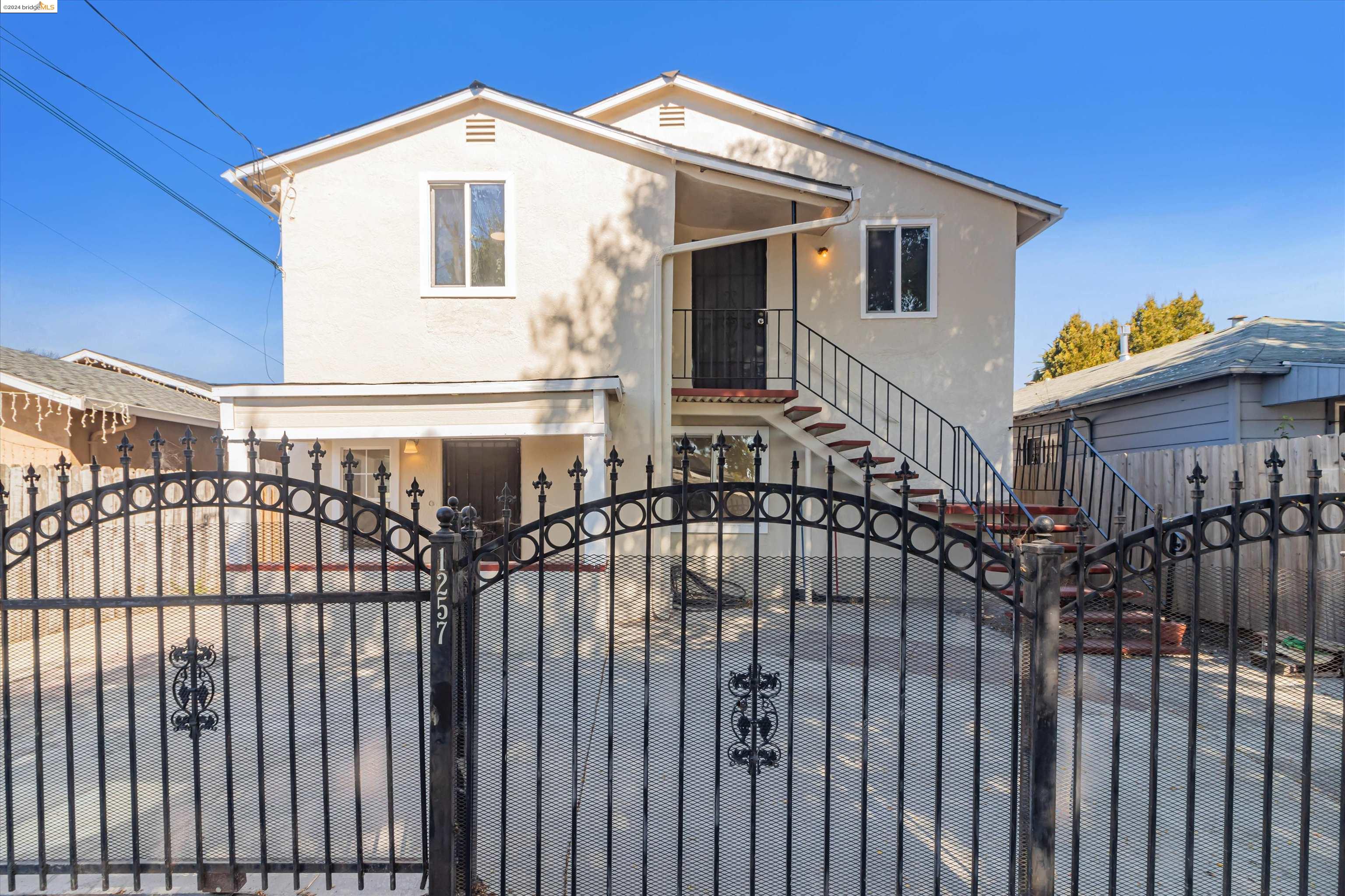 a view of a house with wooden fence