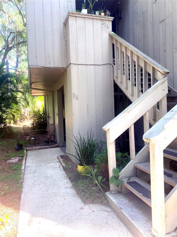 a view of a house with a yard and sitting area