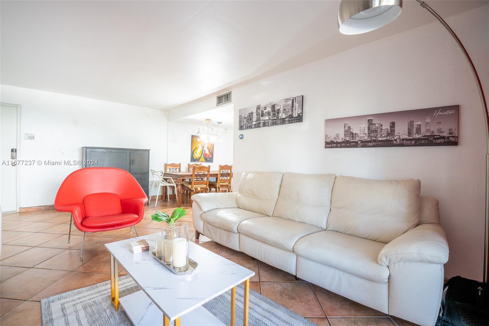 a living room with furniture and kitchen view