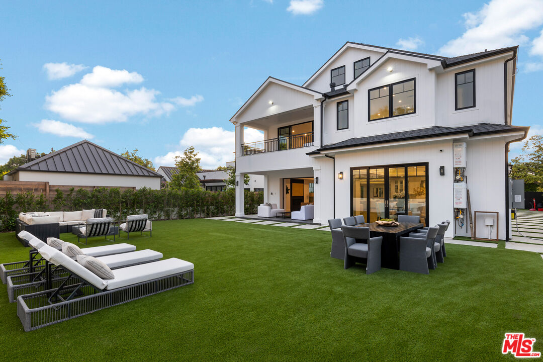 a view of a house with backyard porch and sitting area