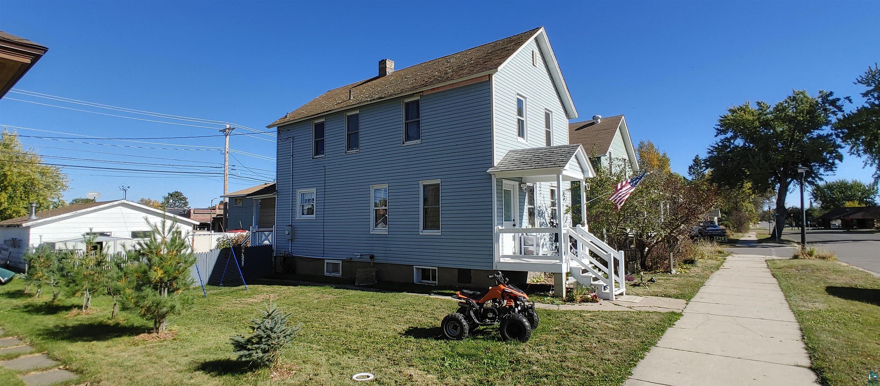 View of property exterior featuring a lawn