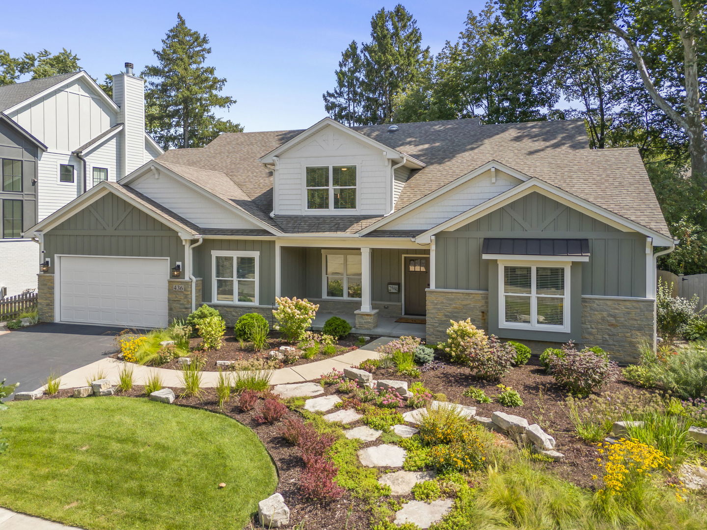 a front view of a house with a yard and outdoor seating