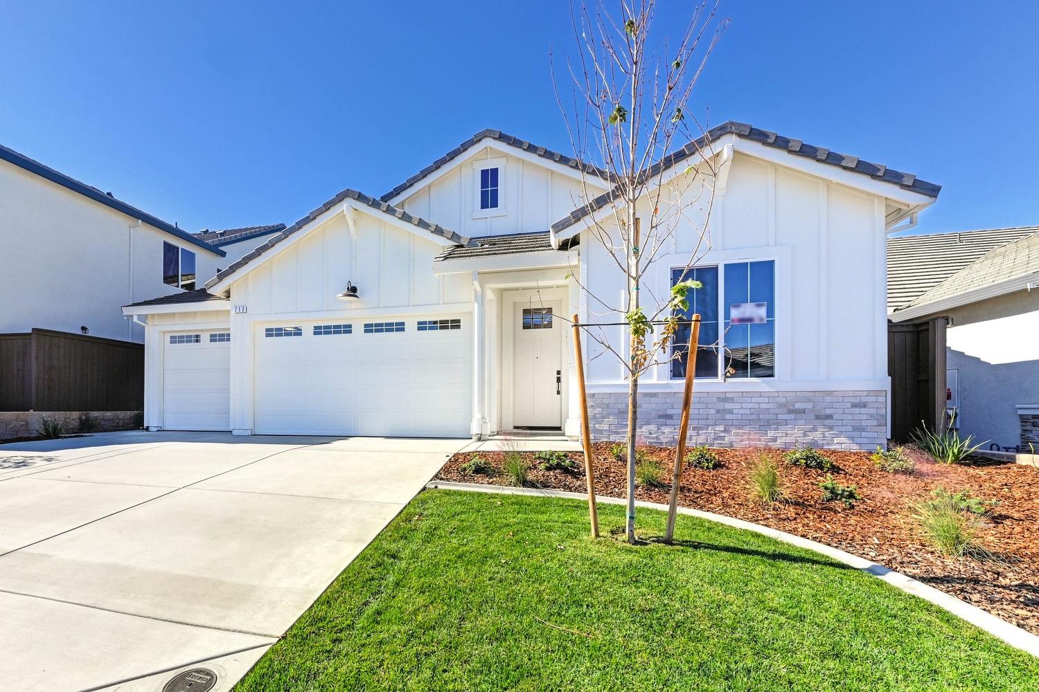 a front view of a house with a yard