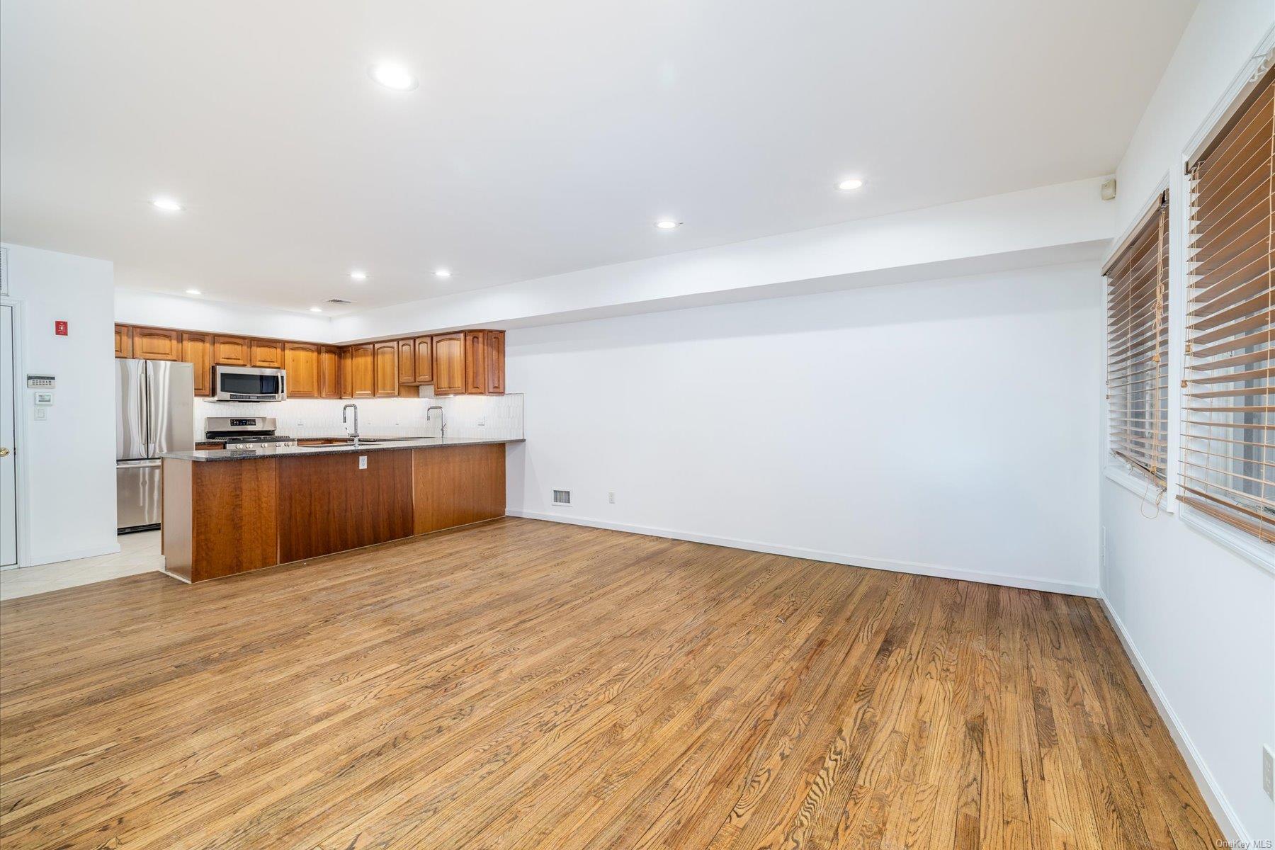 a view of kitchen with wooden floor and electronic appliances