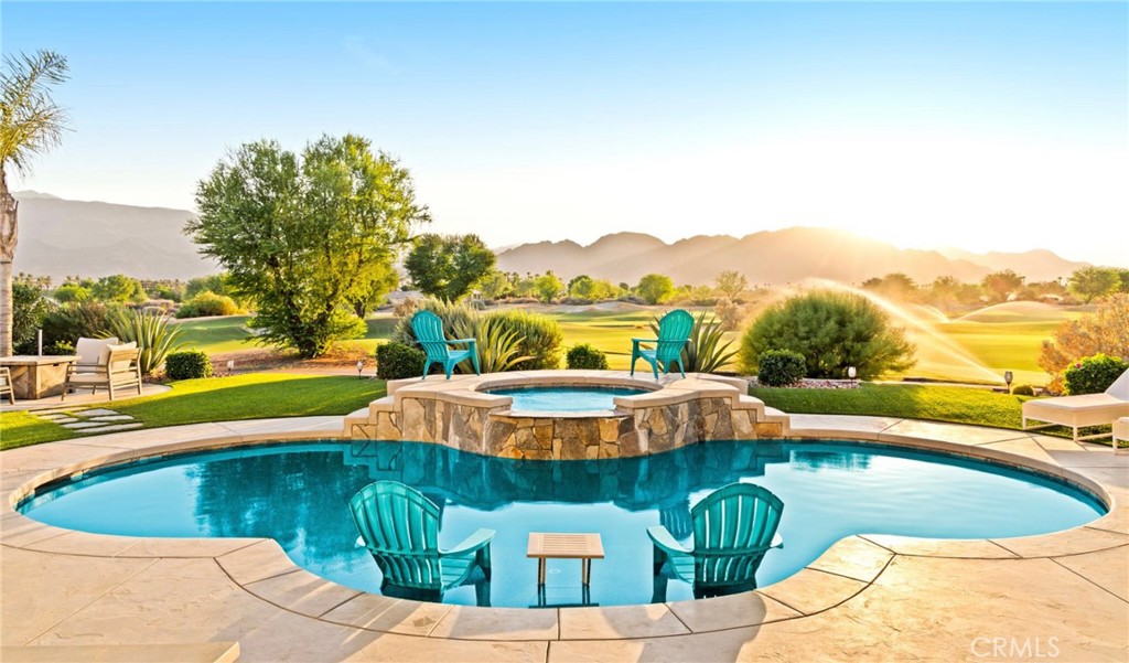 a view of a swimming pool with a yard and plants