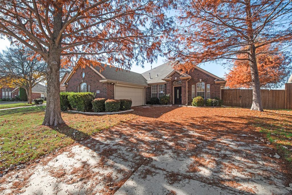 a front view of a house with a yard covered in snow