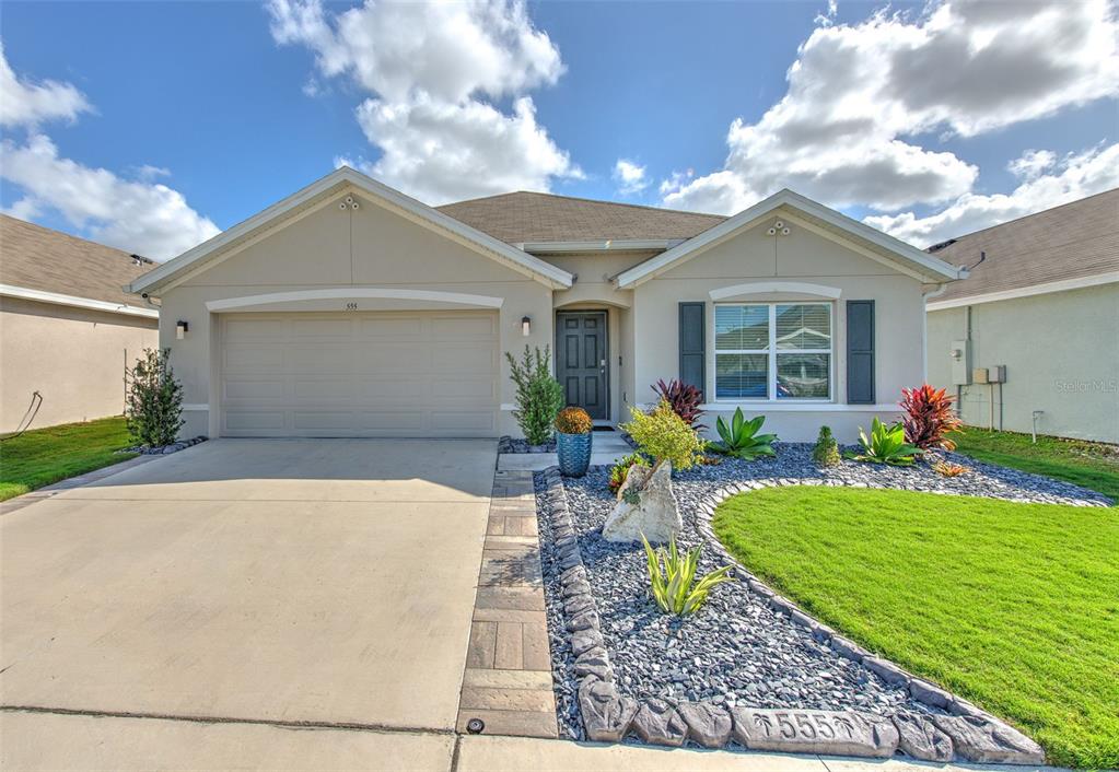 a front view of house with yard and outdoor seating