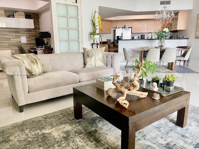 a living room with furniture and a dining table