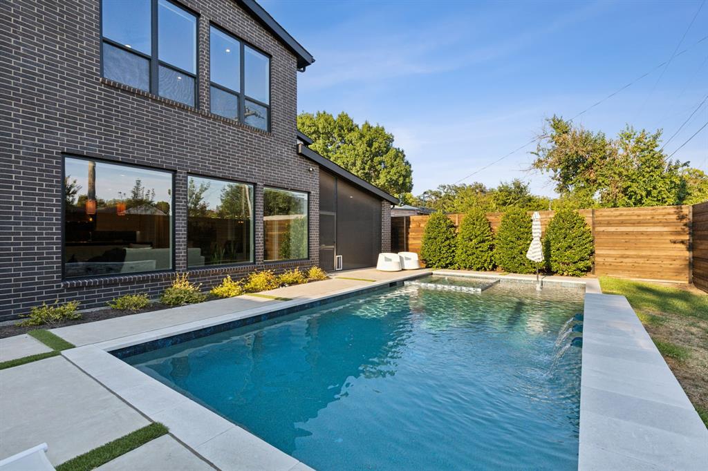 a view of a house with a swimming pool and sitting area