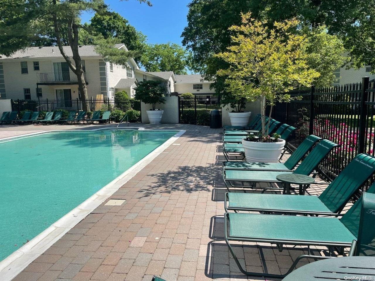 a view of a patio with chairs and a fire pit