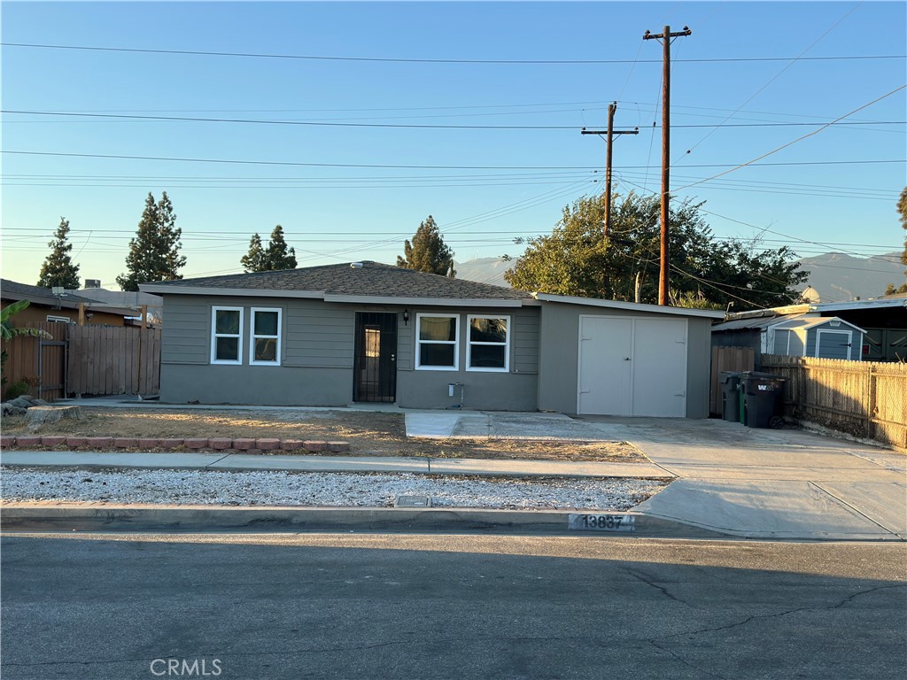 a view of a house with a yard and sitting area