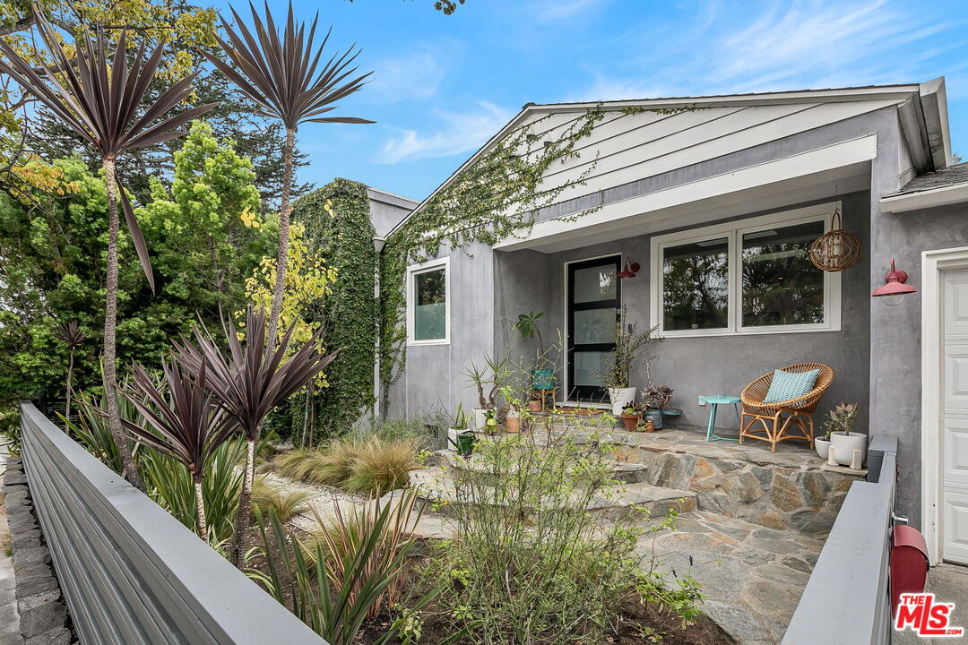 a view of a house with backyard and sitting area