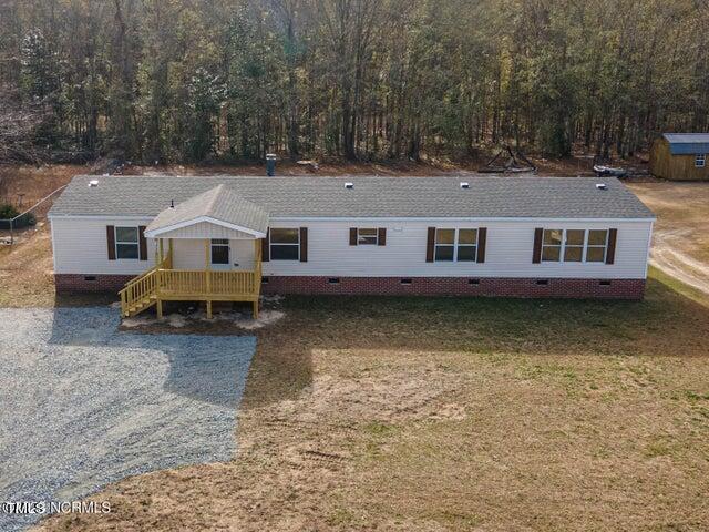 an aerial view of a house with swimming pool and a yard