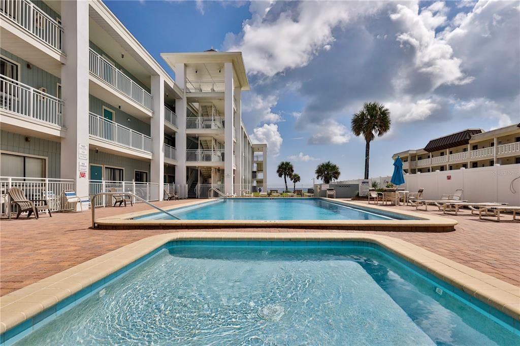 a view of a swimming pool with an outdoor seating