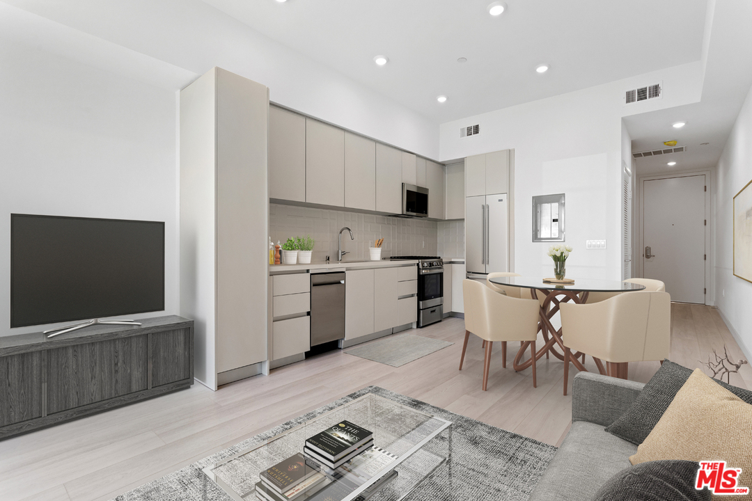 a open kitchen with stainless steel appliances kitchen island granite countertop a sink and cabinets