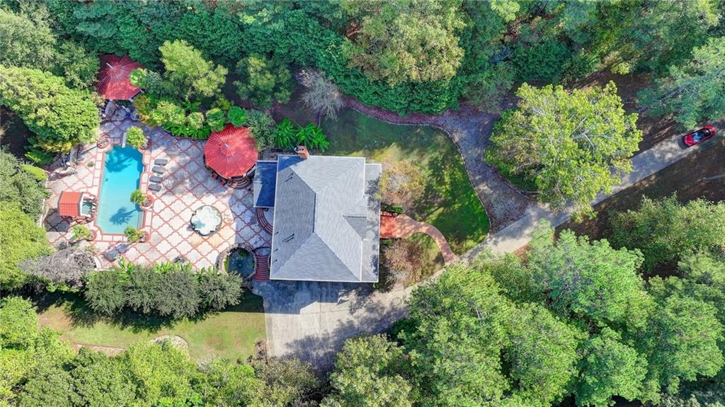 an aerial view of a house with a yard and lake view