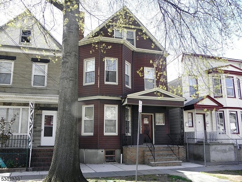 a front view of a residential apartment building with a yard