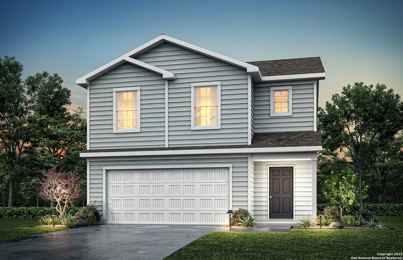 a front view of a house with a yard and garage