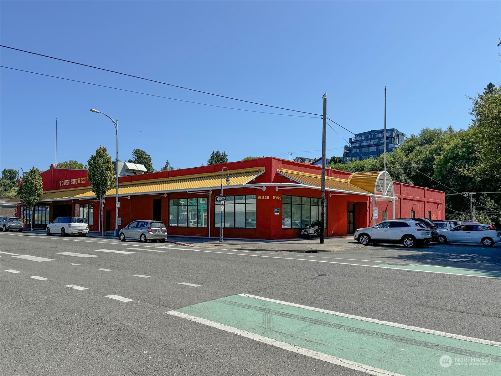 a view of a cars park in front of a building