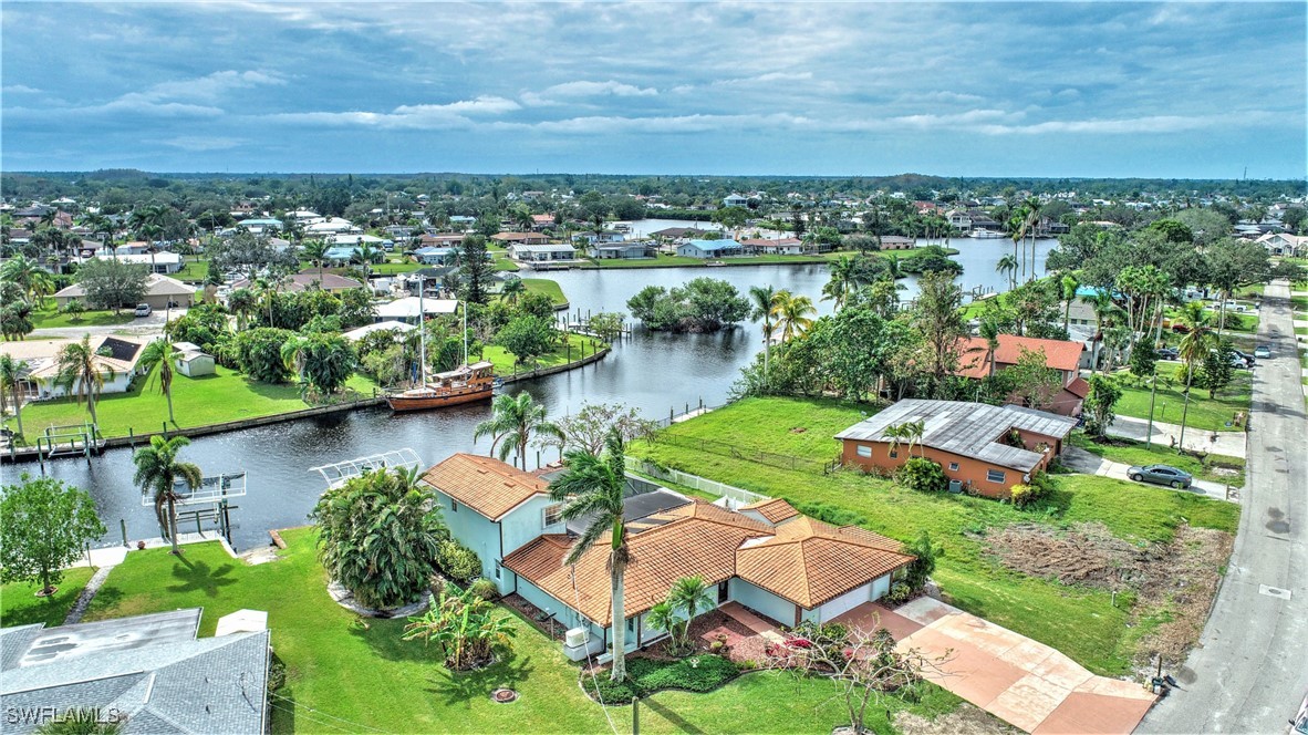 an aerial view of a house with a lake view