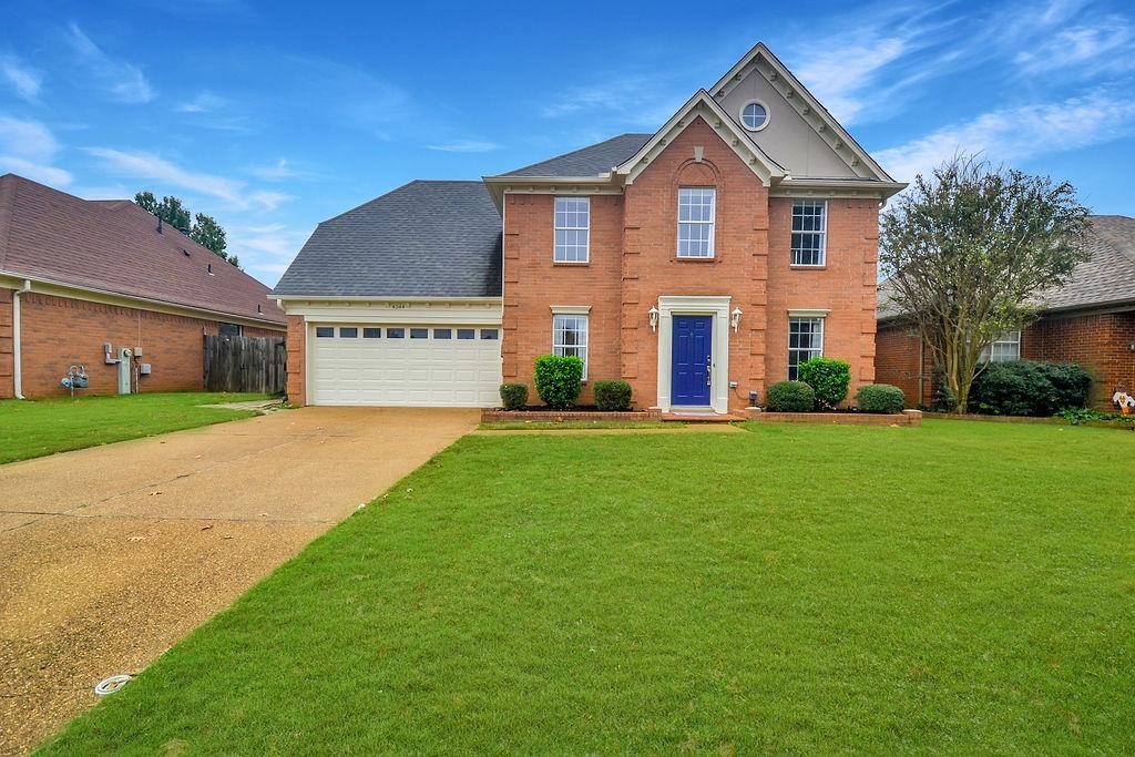 a front view of a house with a yard