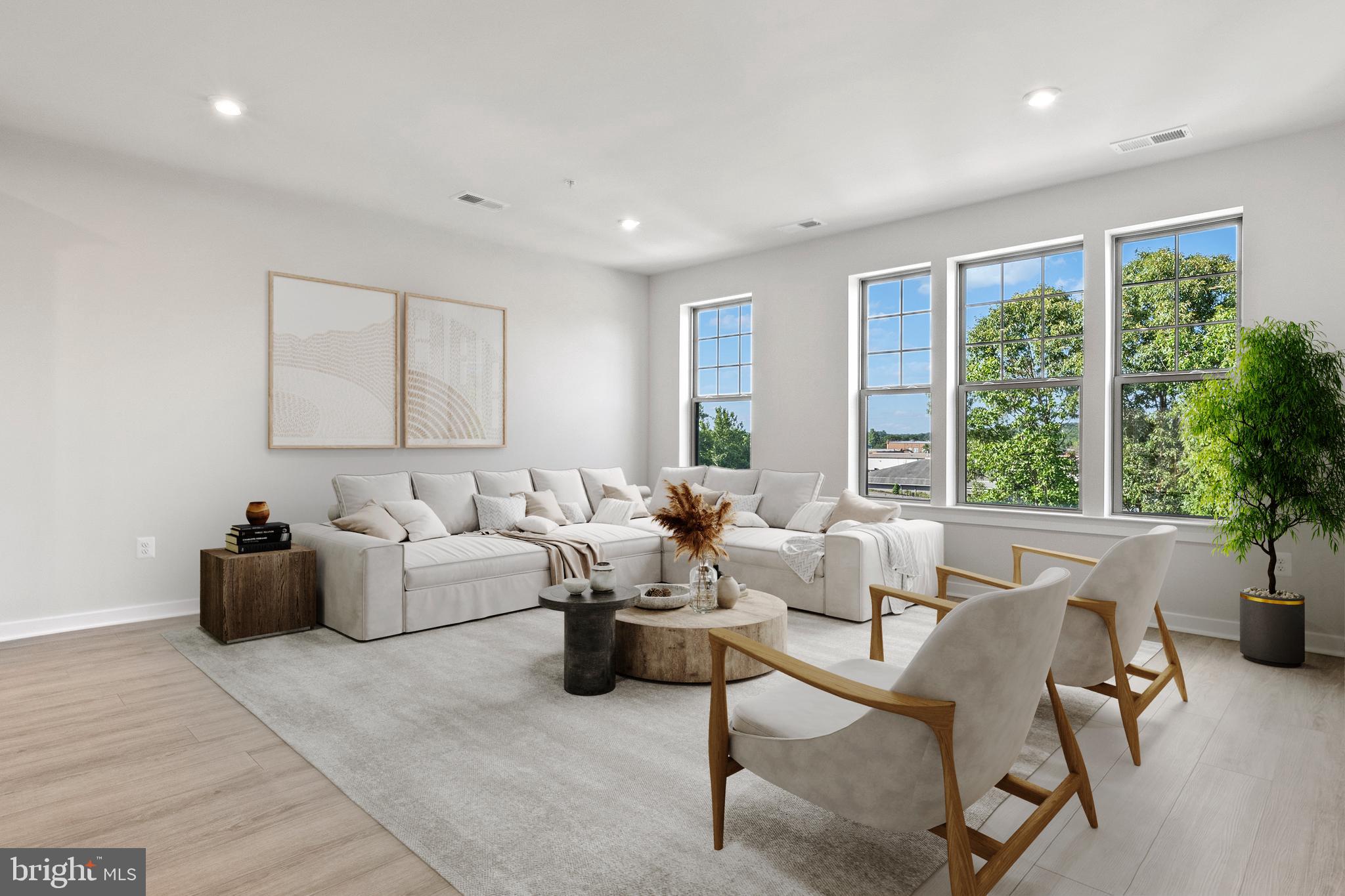 a living room with furniture and large windows