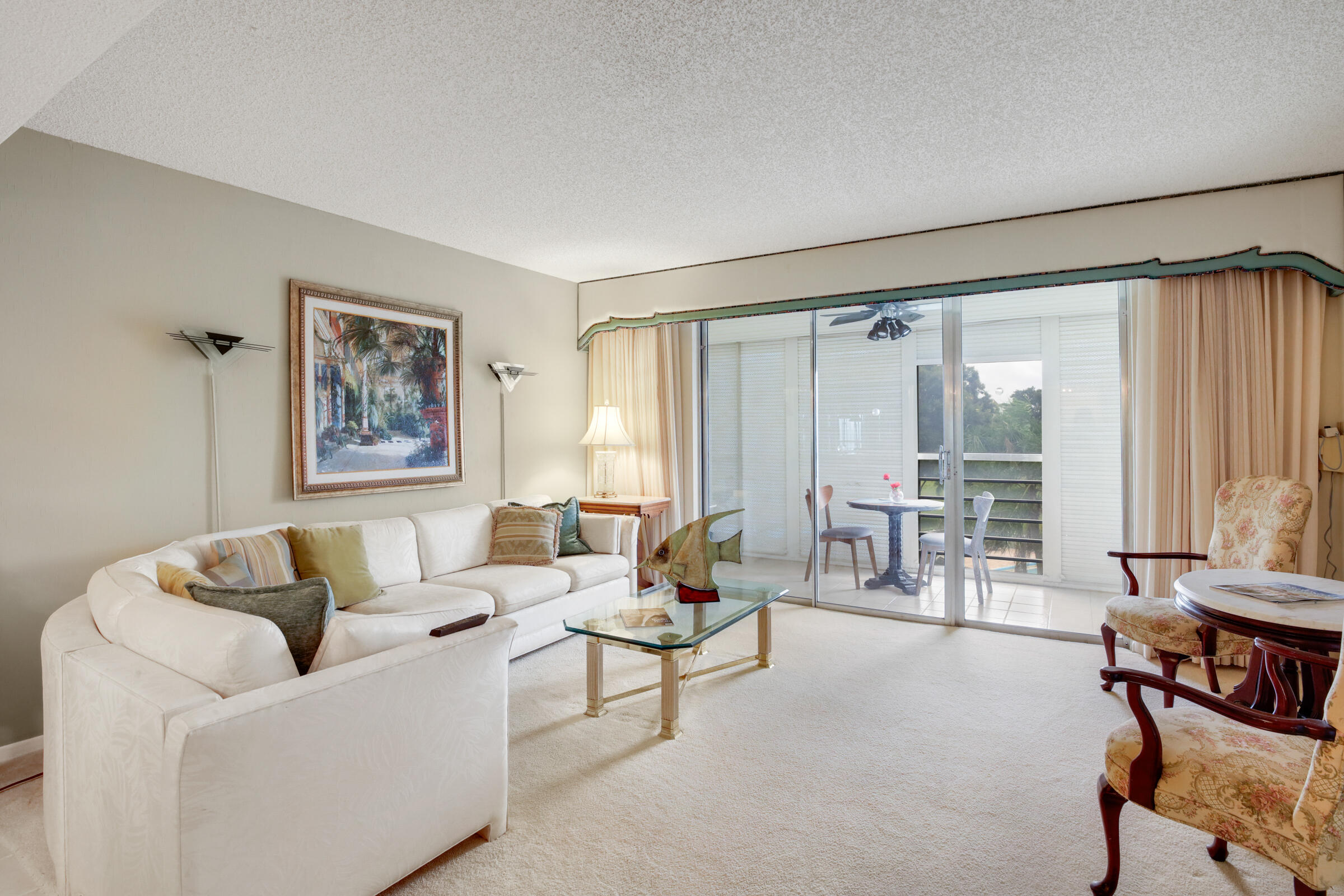 a living room with furniture and large windows