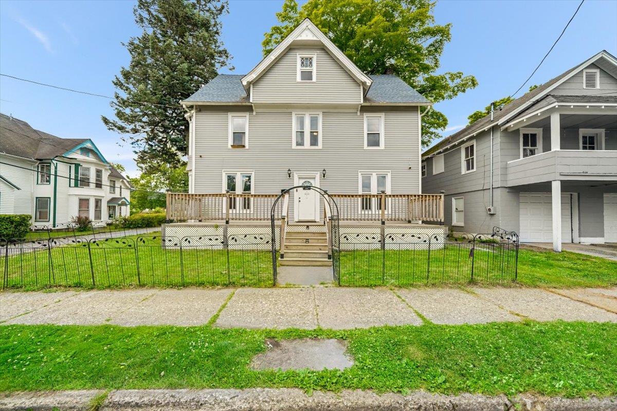 View of front of house with a front lawn and a porch