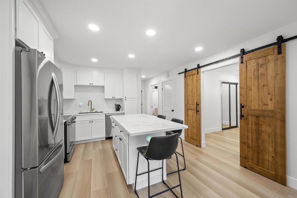 a kitchen with a refrigerator a sink and cabinets