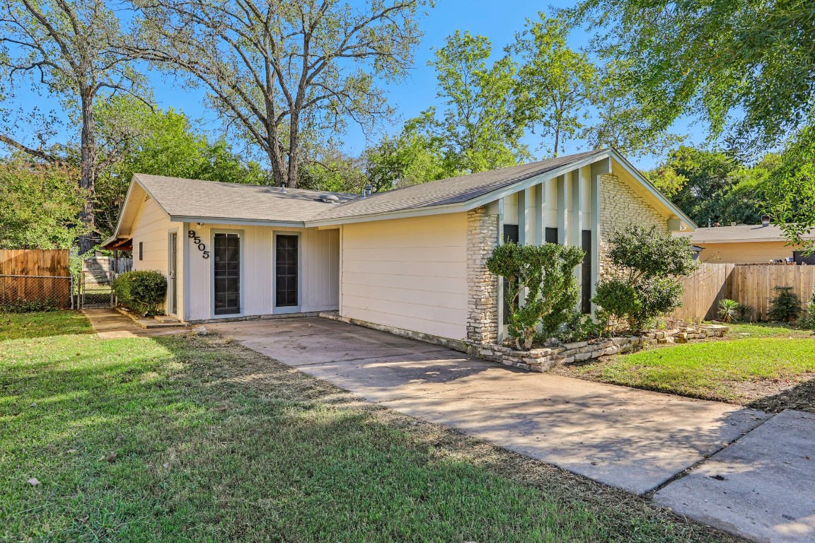 a view of a yard in front view of a house