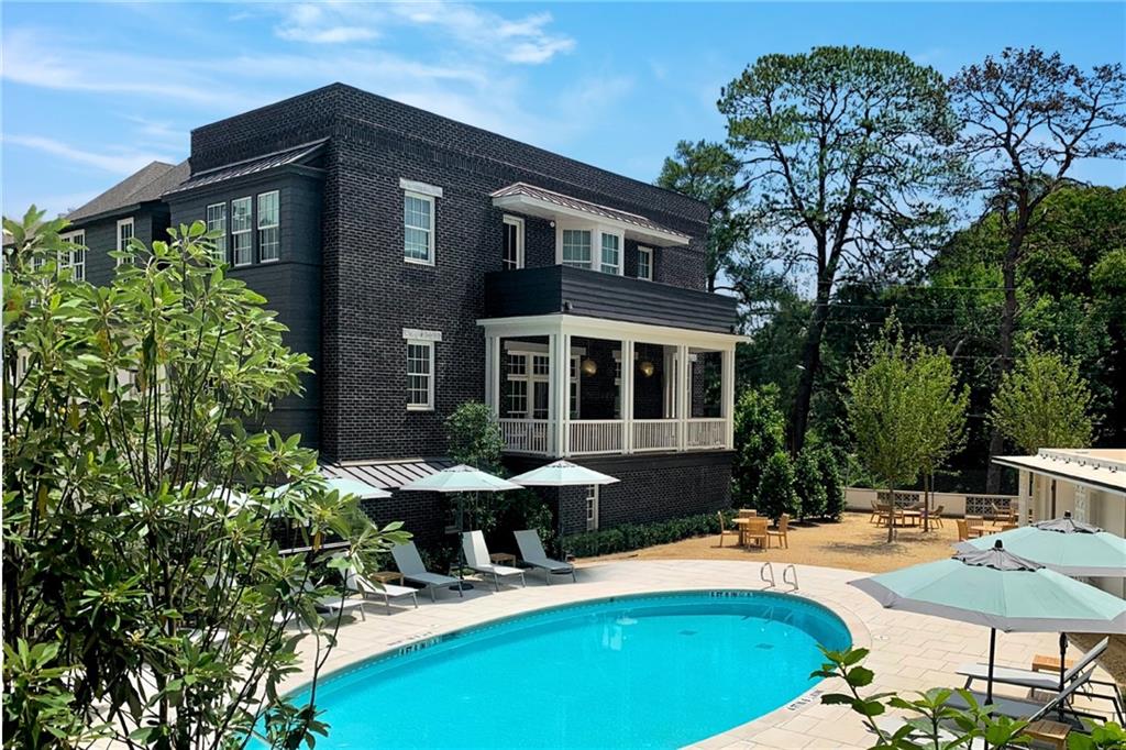 a view of a house with swimming pool and sitting area