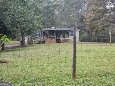 a backyard of a house with table and chairs