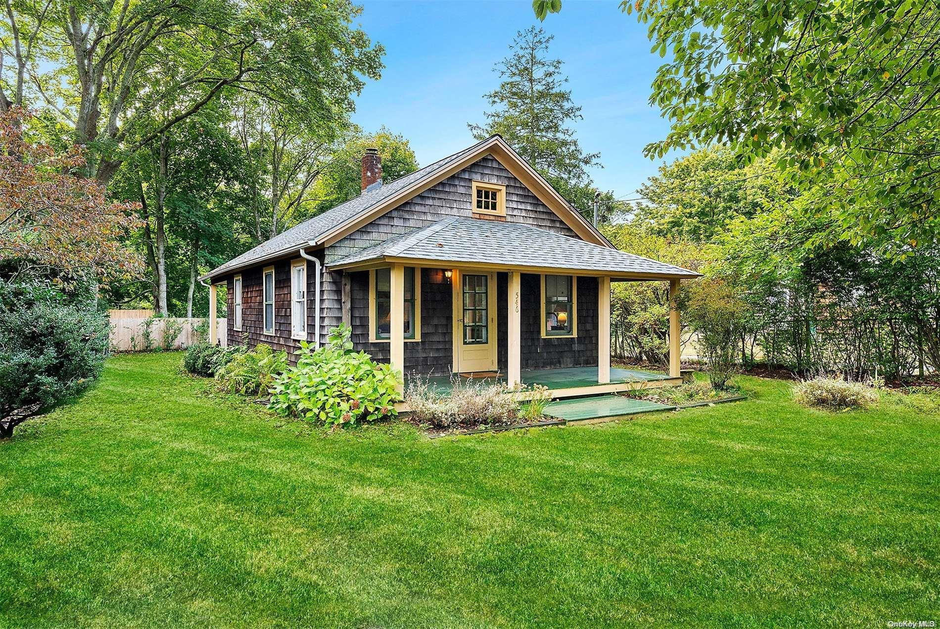 a front view of a house with garden and porch