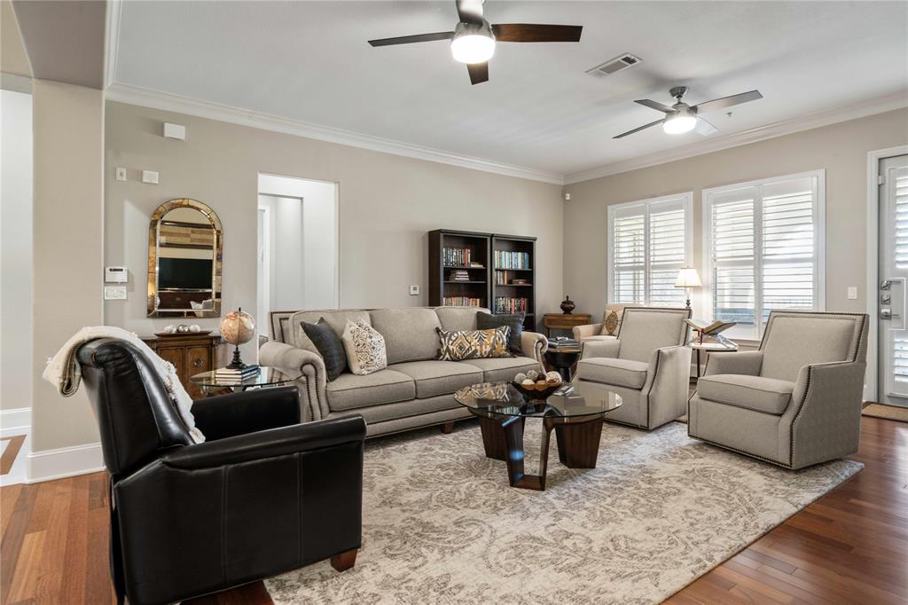 a living room with furniture ceiling fan and a window