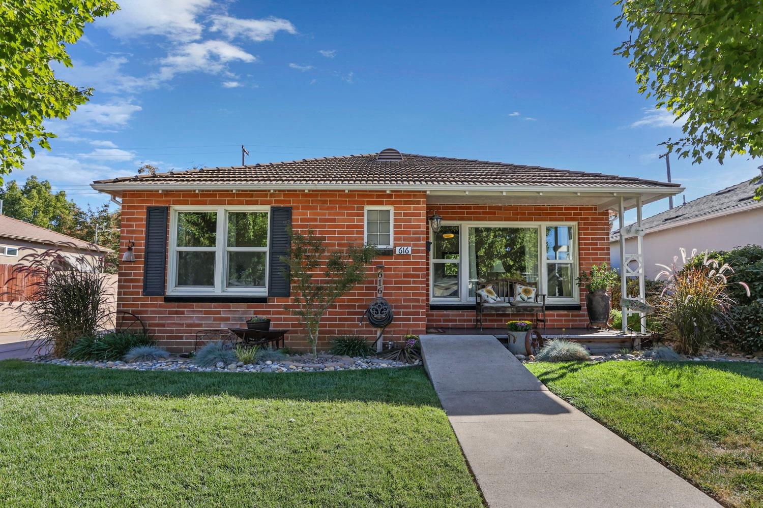 a front view of a house with garden