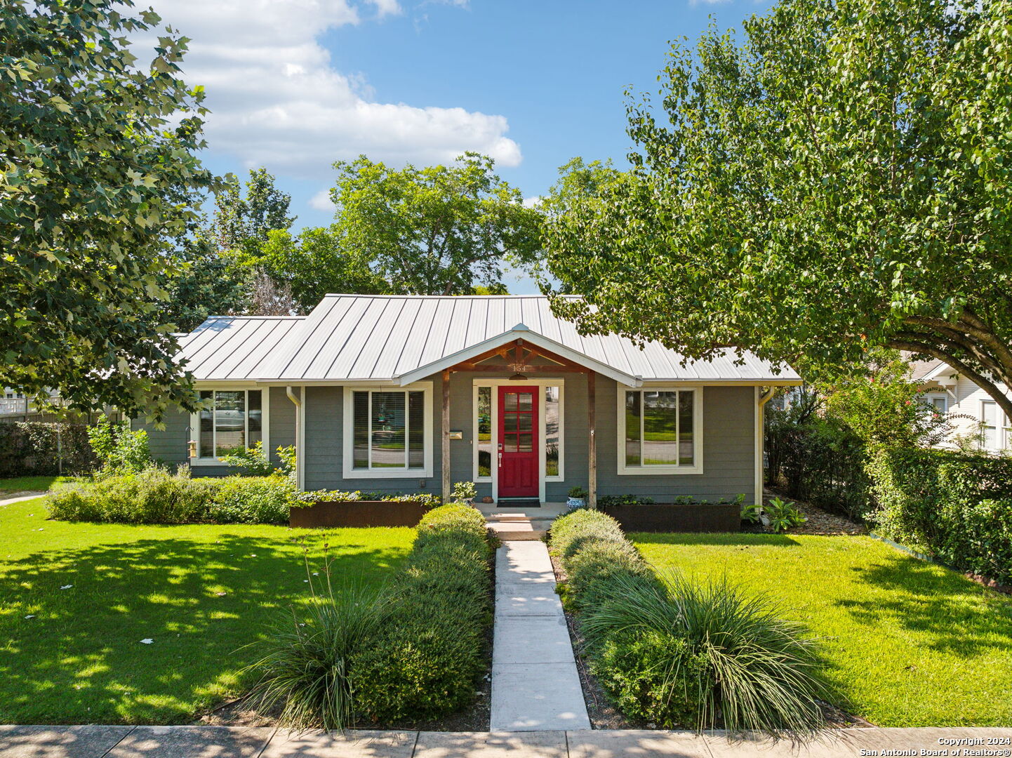 a front view of house with yard and green space