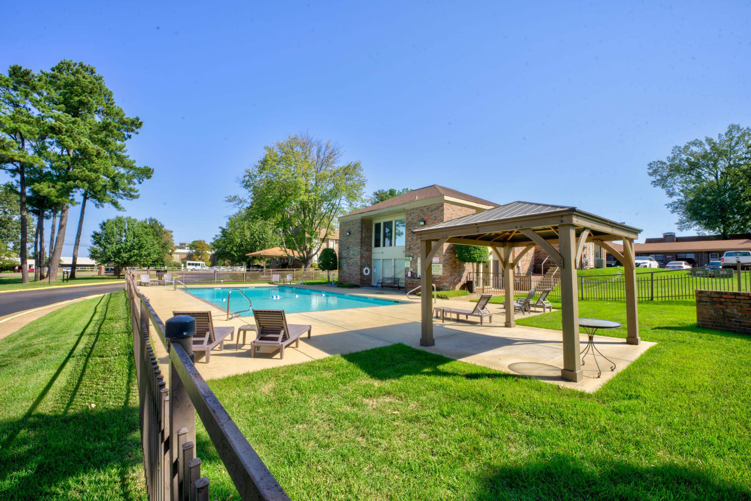 a view of a house with backyard and a patio